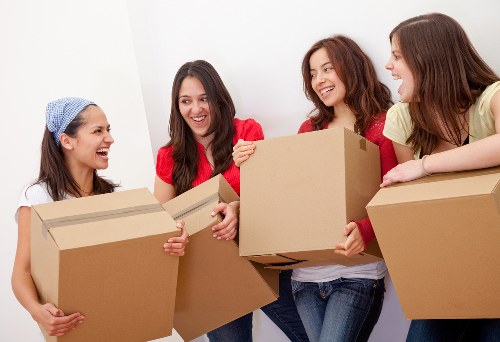 Mover carrying boxes with protective equipment during a relocation