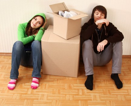 Eco-friendly moving team handling boxes with reusable packing materials