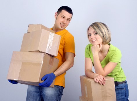 Professional movers handling furniture during a relocation