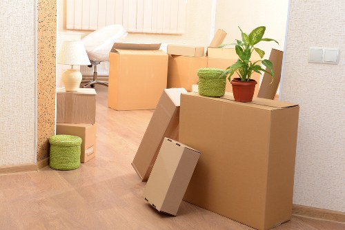Local movers carrying items through a West Hampstead building
