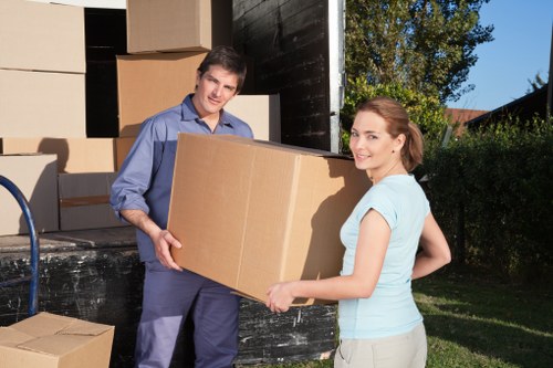 Packed office boxes and furniture ready for transport in NW6