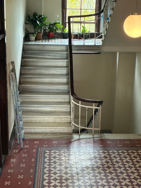 A photograph shows the front entrance of a residential property with a set of external stairs leading up to two white front doors, each with glass panels and decorative trim. The staircase is tiled wi